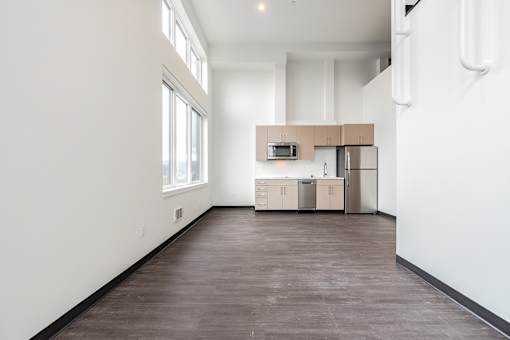 A kitchen area with a refrigerator, microwave, and oven.