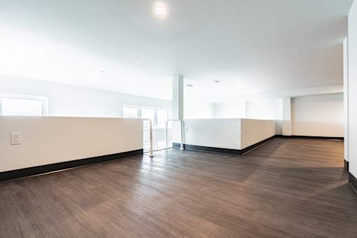 A room with a wooden floor and white walls.