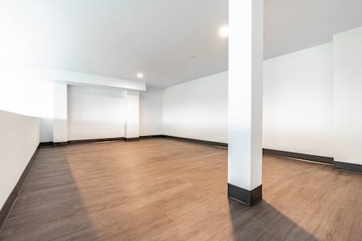 A room with wooden floors and white walls.