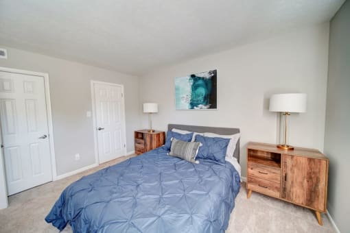 a bedroom with a bed and two night stands