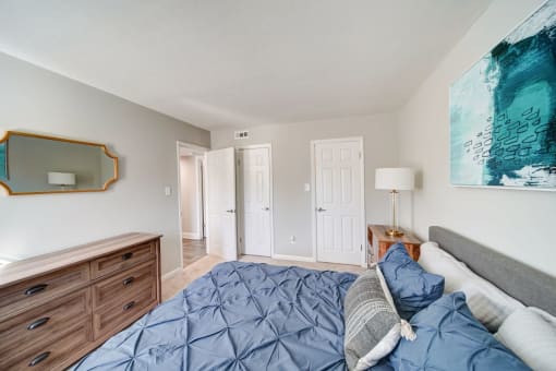 a bedroom with a bed and dresser