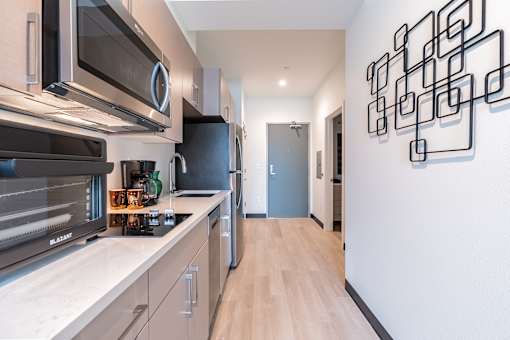 A modern kitchen with a wall art on the wall.