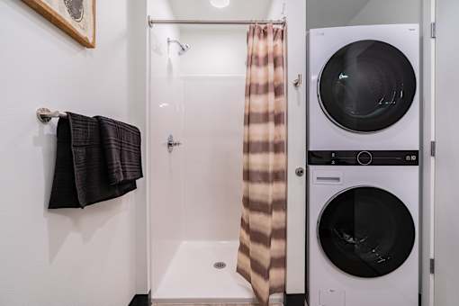 A small bathroom with a washer and dryer.