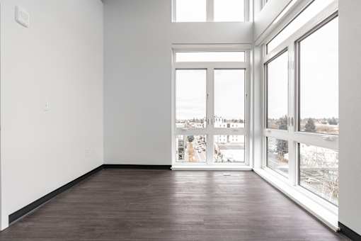 A room with a view of a snowy landscape outside the windows.