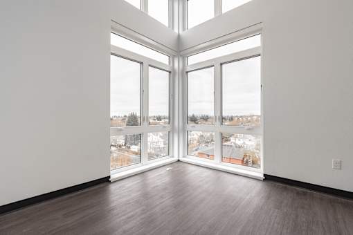 A room with a large window and a view of a snowy landscape.