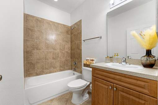 Three- & Four-Bedroom Townhomes in Kissimmee, FL - Estates at Lake Cecile – A bathroom with a white toilet and a white bathtub.