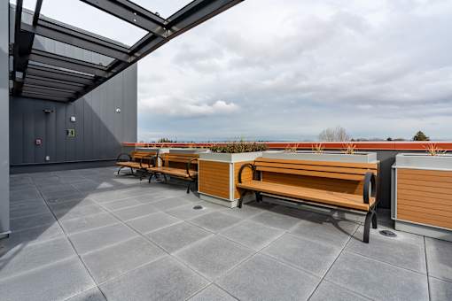 A patio with a bench and a table.
