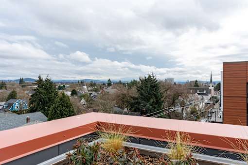 A view from a balcony overlooking a cityscape.