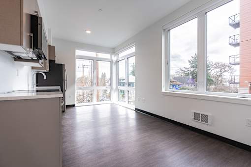 A kitchen with a counter and a window overlooking a residential area.
