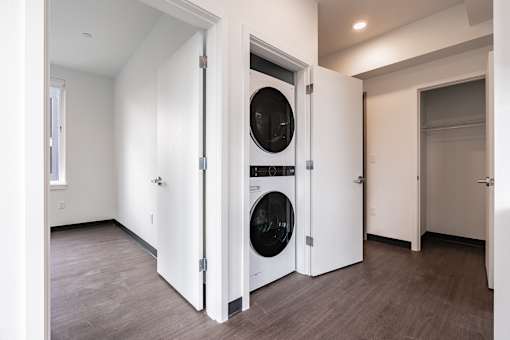 A laundry room with a washer and dryer built into the wall.
