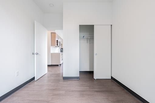 A long hallway with a door on the right.