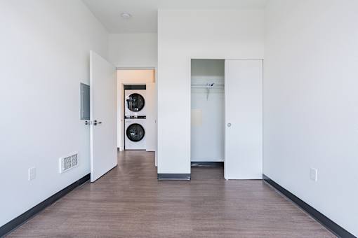 A long hallway with a door on the left and a door on the right.