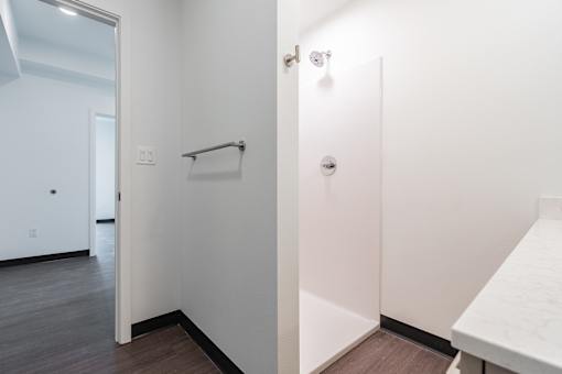 A white bathroom with a towel bar and a toilet.