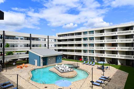 A large apartment complex with a pool and hot tub.