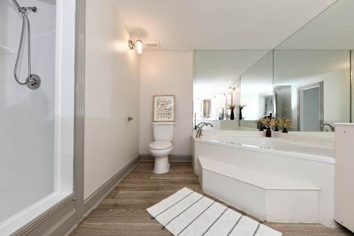 A white bathroom with a toilet, sink, and bathtub.