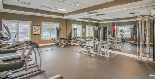 a fitness center with cardio equipment and weights