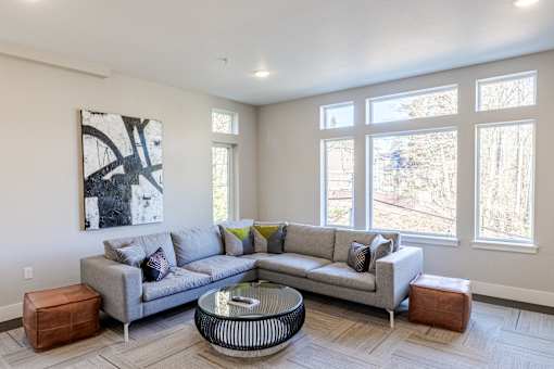 A living room with a grey couch and a coffee table at Emerald Crest, Bothell, Washington