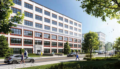 A modern building with a red and white facade and people walking in front.
