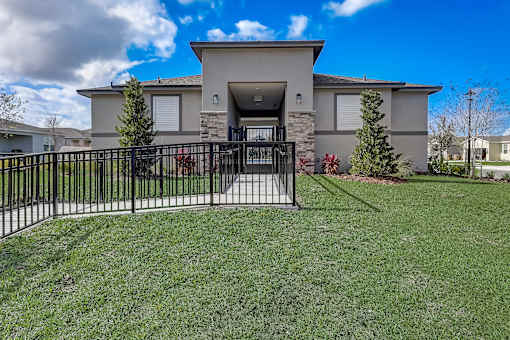 A house with a black gate in front of it.