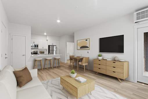 A modern living room with a white couch, wooden furniture, and a flat-screen TV.