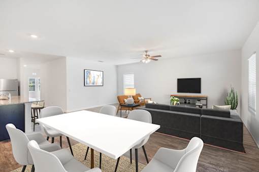 A modern dining room with a white table and chairs.