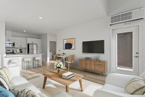 A living room with a white couch, a wooden coffee table, and a painting on the wall.
