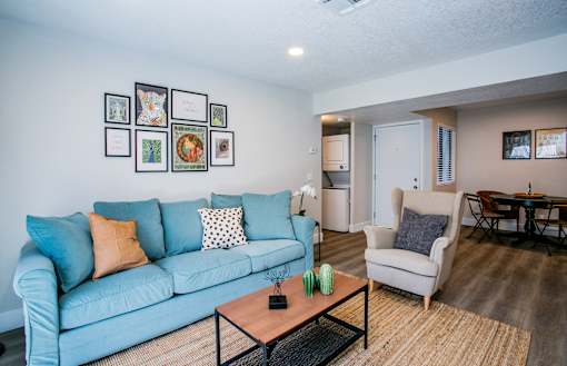 Bright apartment living room with wood-style flooring at Haven at Lone Mountain in Las Vegas