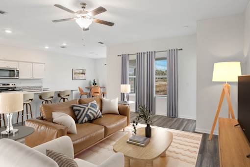 A living room with a brown leather couch and a wooden coffee table.