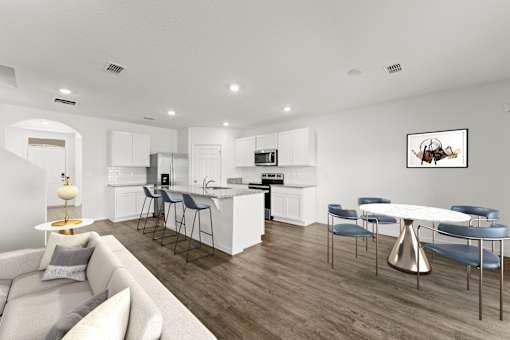 A modern kitchen with a dining table and chairs.