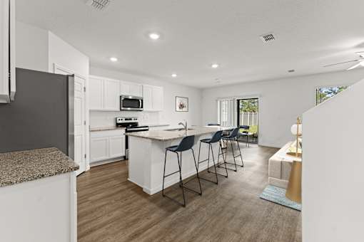 A modern kitchen with white cabinets and a central island.