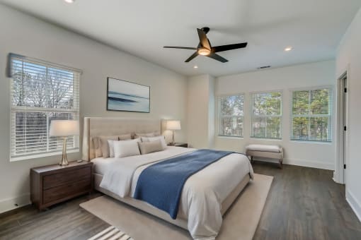 Luxury Townhomes in Avondale Estates, GA 30002 for Rent – Henley Avondale - master bedroom with a large bed and a ceiling fan and hardwood floors