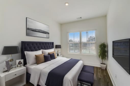 Luxury Four Bedroom Townhomes in Avondale Estates, GA - Henley Avondale –bedroom with a large bed and a window and hardwood flooring