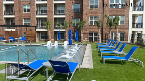 Heritage towers apartments an outdoor pool with lounge chairs and umbrellas in front of an apartment building lewisville tx apartments apartments near lewisville tx lewisville apartments