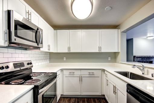 renovated unit kitchen featuring white cabinets,
