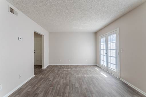 Apartments in Antioch, TN 37013 for Rent – Hickory Lake - A room with a wooden floor and a window with blinds.