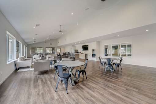 Spacious clubhouse with modern seating at Hinton Heights Apartments in Cottage Grove, MN, offering inviting shared spaces for residents of 1, 2, and 3 bedroom apartments for rent.