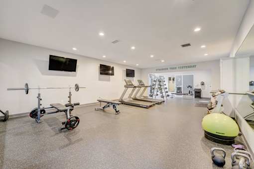 Modern fitness center with cardio and strength equipment at Hinton Heights Apartments in Cottage Grove, MN, serving residents of 1, 2, and 3 bedroom apartments for rent.