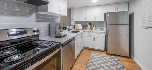 Horizons North Apartments in Miami Florida photo of a kitchen with white cabinets and stainless steel appliances