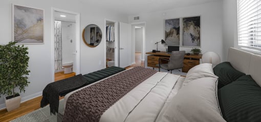 Horizons North Apartments near Andover, FL photo of a bedroom with a bed and a desk in a room