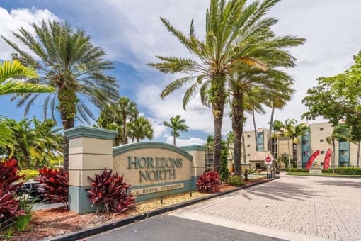 Horizons North Apartments in Miami Florida photo of a sign that says horizons north with palm trees in the background