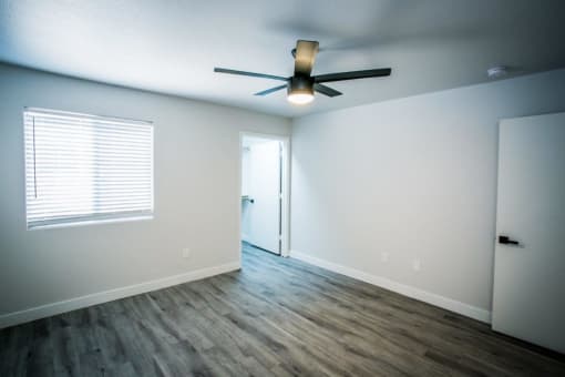 an empty room with a ceiling fan