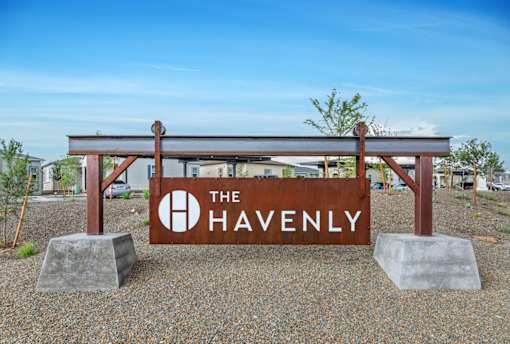 A sign that says "The Havenly" is in front of a building.