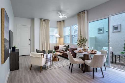 A modern dining room with a glass table and chairs.