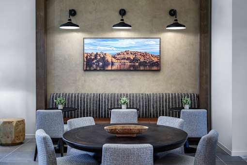 A dining room with a large table and chairs.