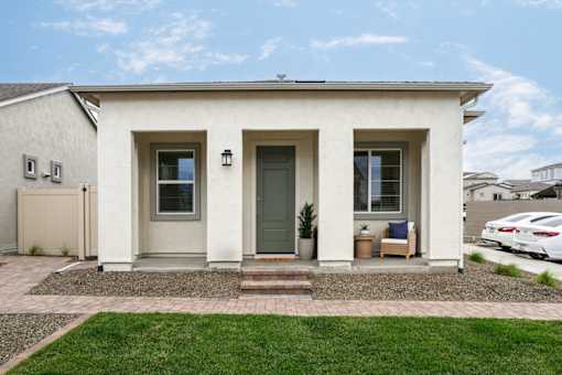 A small house with a grey door and windows.