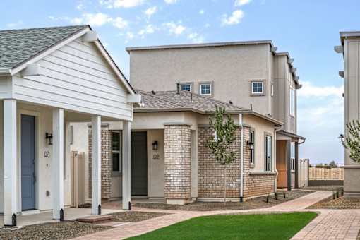 A row of houses with a blue sky in the background.
