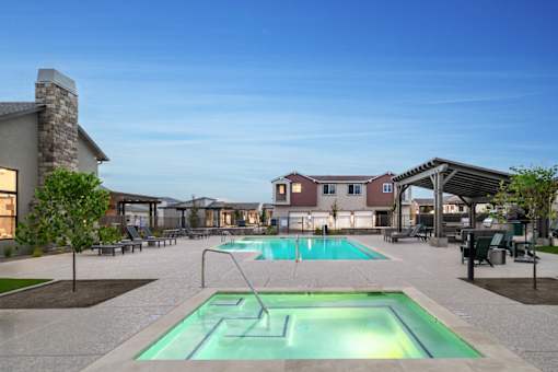 A swimming pool with a greenish hue in the middle of a residential area.