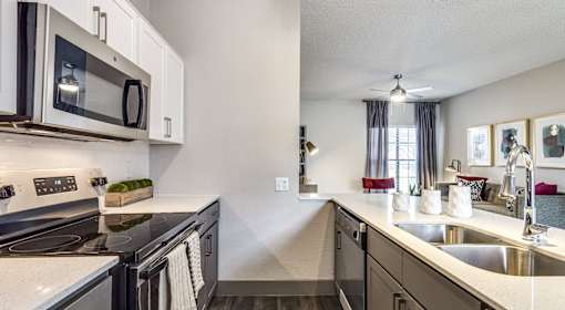A modern kitchen with a stainless steel oven and microwave.
