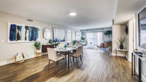 A dining room with a wooden table and chairs.