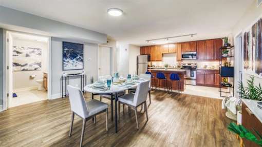 A dining area with a table set for four.